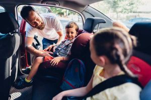 En voiture, un père et ses deux enfants